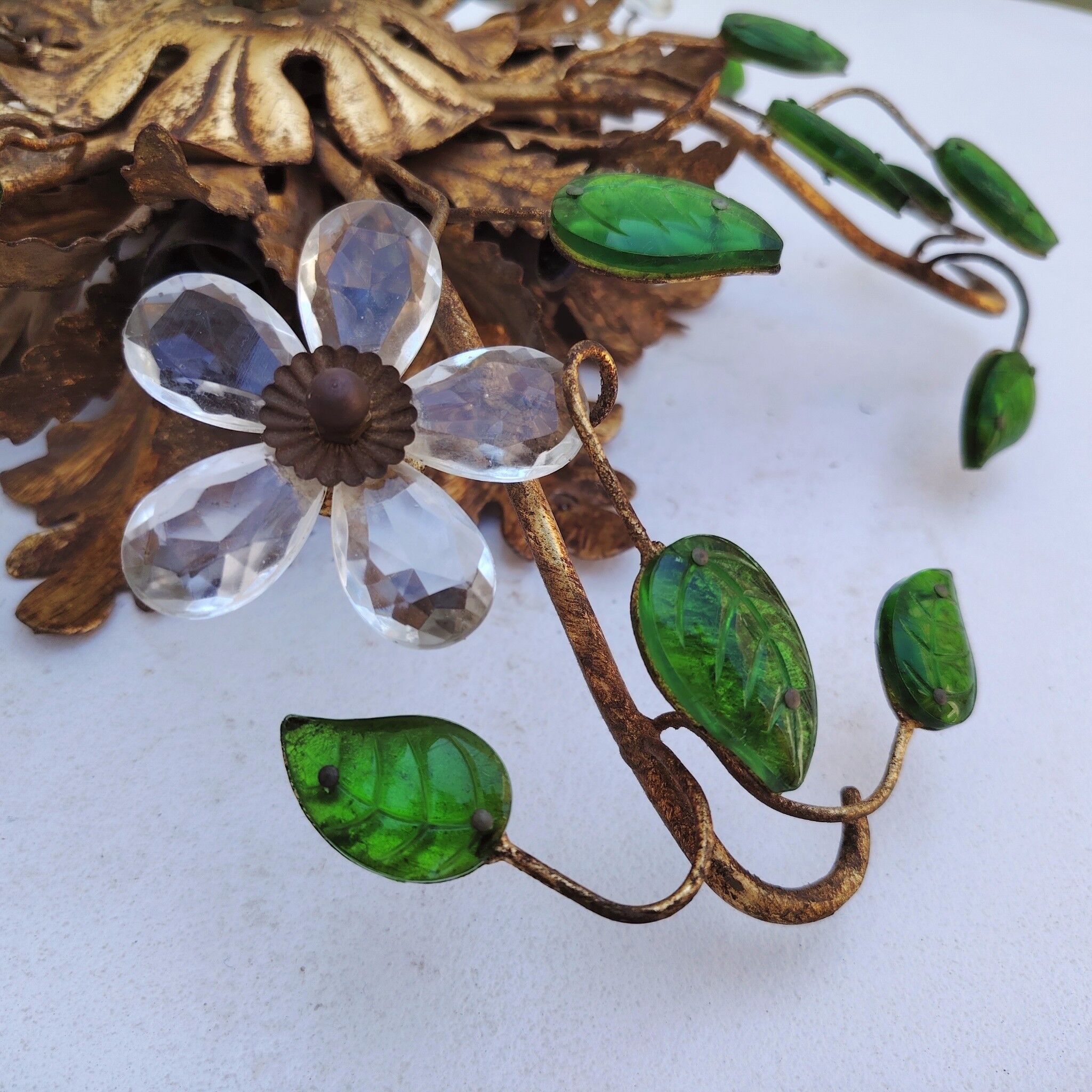 Flower wall light, gilded metal and glass cabochons, attributed to Baguès.