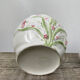 White ceramic pot cache in old flower slip