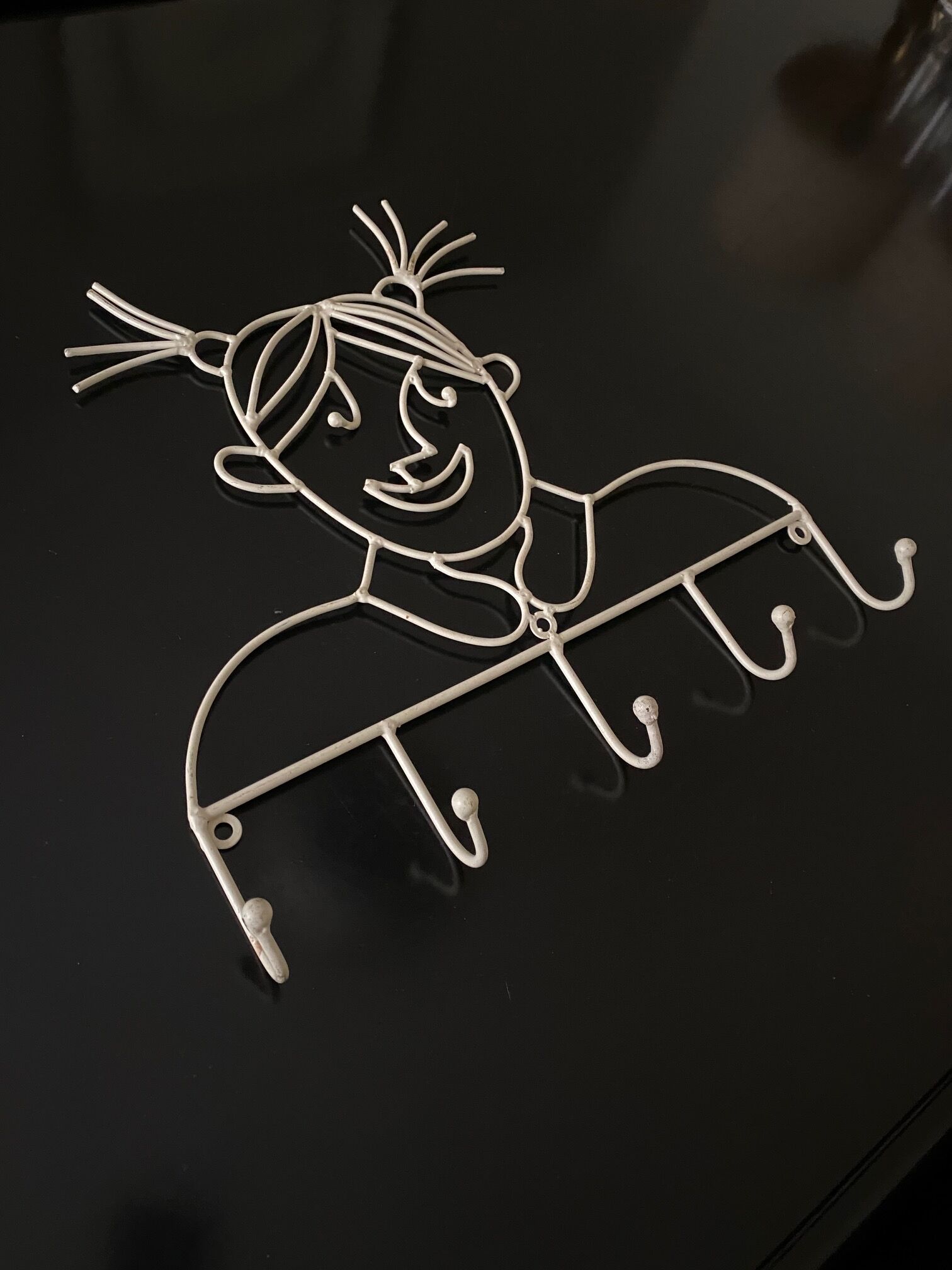 Pair of iron coat holders girl and boy