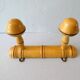 Coat rack with 2 wooden hooks imitating bamboo.