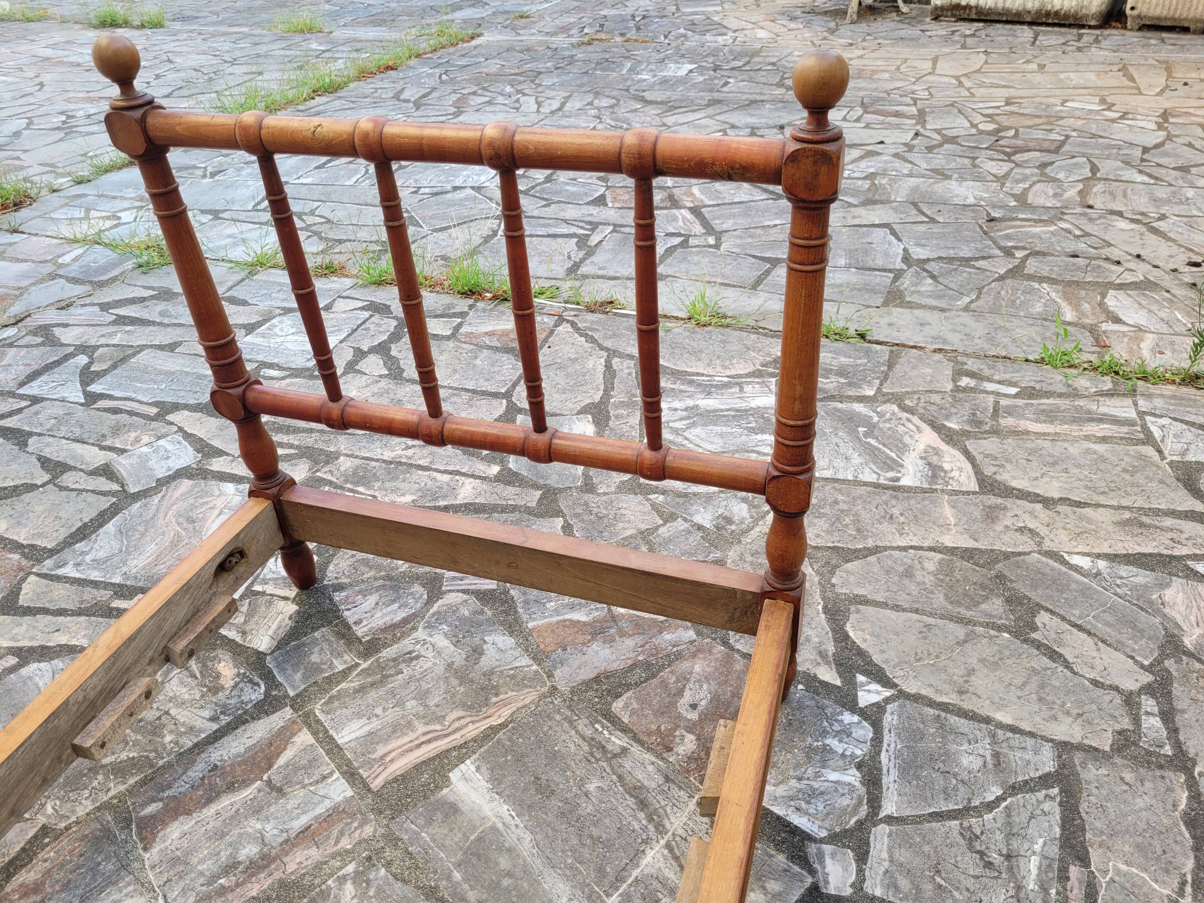 Child's bed or vintage rest bed made of solid cherry wood in a bamboo style.