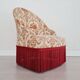 Beige toad armchair with floral patterns and red fringes