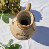 Handcrafted jug or jar with a handle, terracotta pottery vase, fat lava effect, stylized flowers