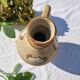 Handcrafted jug or jar with a handle, terracotta pottery vase, fat lava effect, stylized flowers