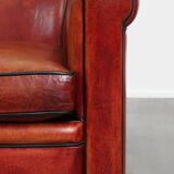 Armchair made of sheepskin leather in a red/brown color