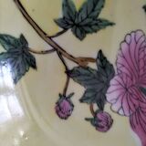 Pair of vintage Chinese decorative plates with floral decoration on a yellow background