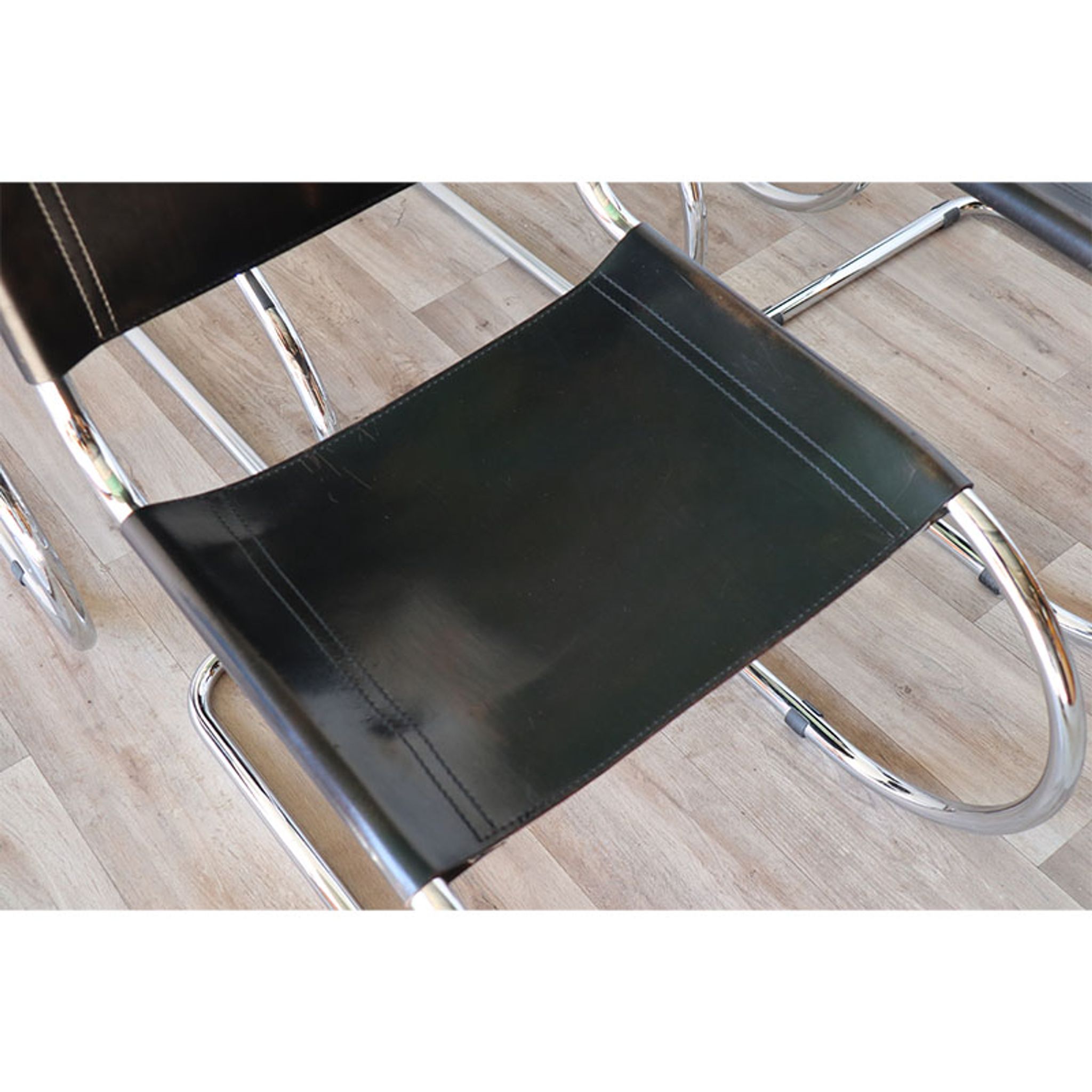 Series of 6 minimalist chairs in chrome metal and black leather around 1970