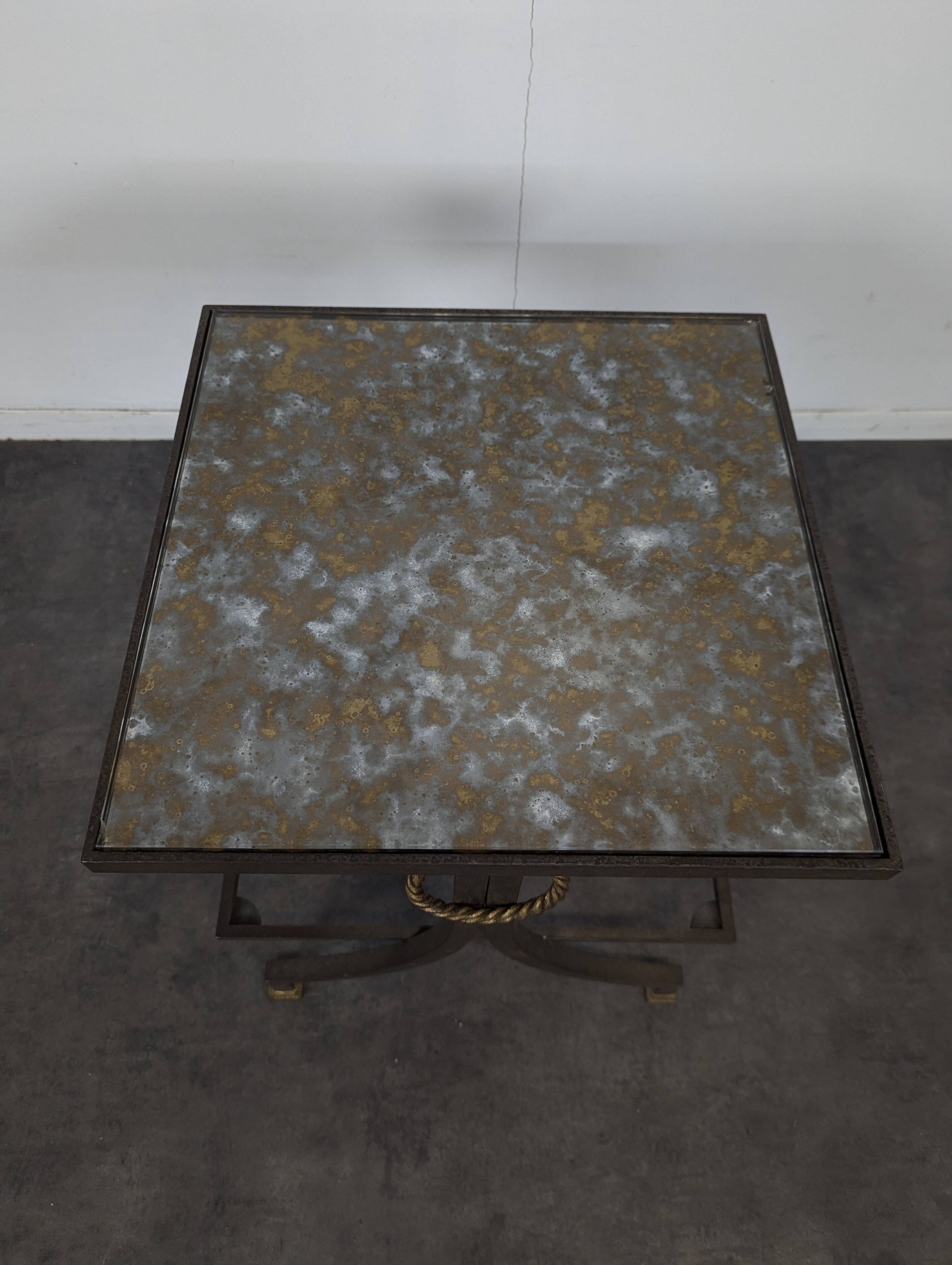 Neoclassical side table in wrought iron and eglomisé glass.