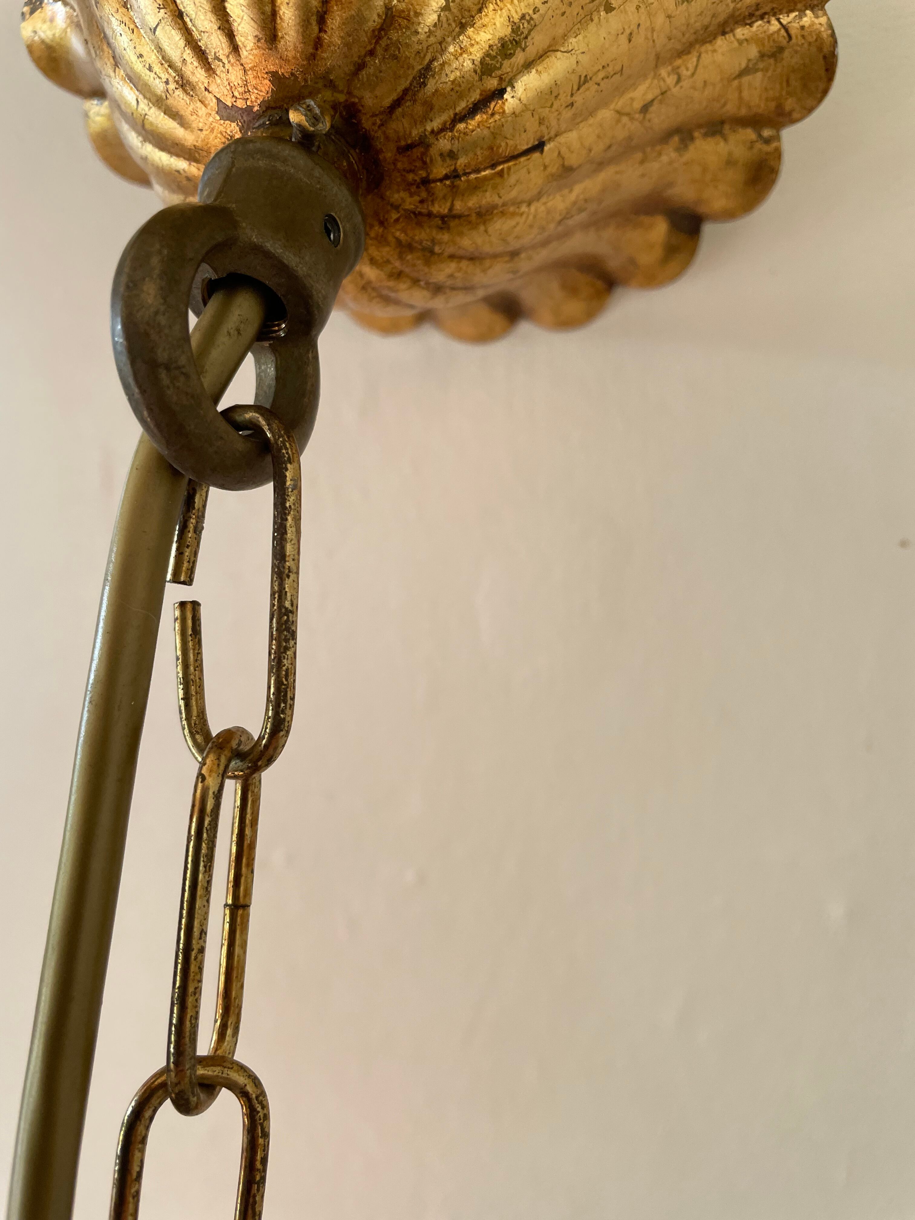 Golden metal chandelier decorated with flowers