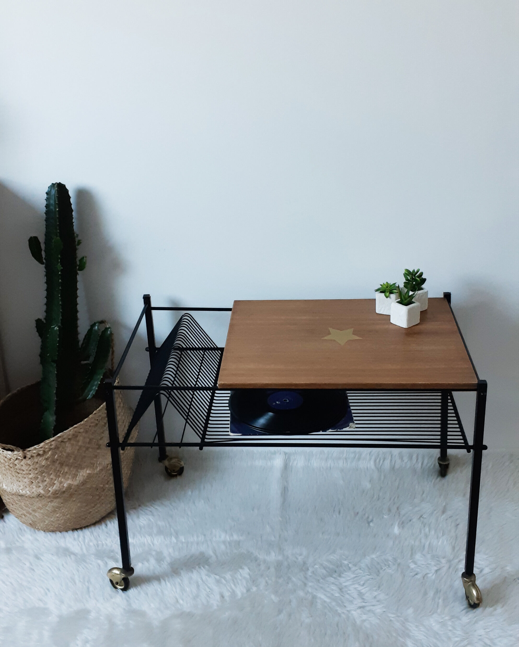 Table has record player, wearing vintage discs