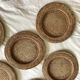 Set of round woven rattan and canework coasters