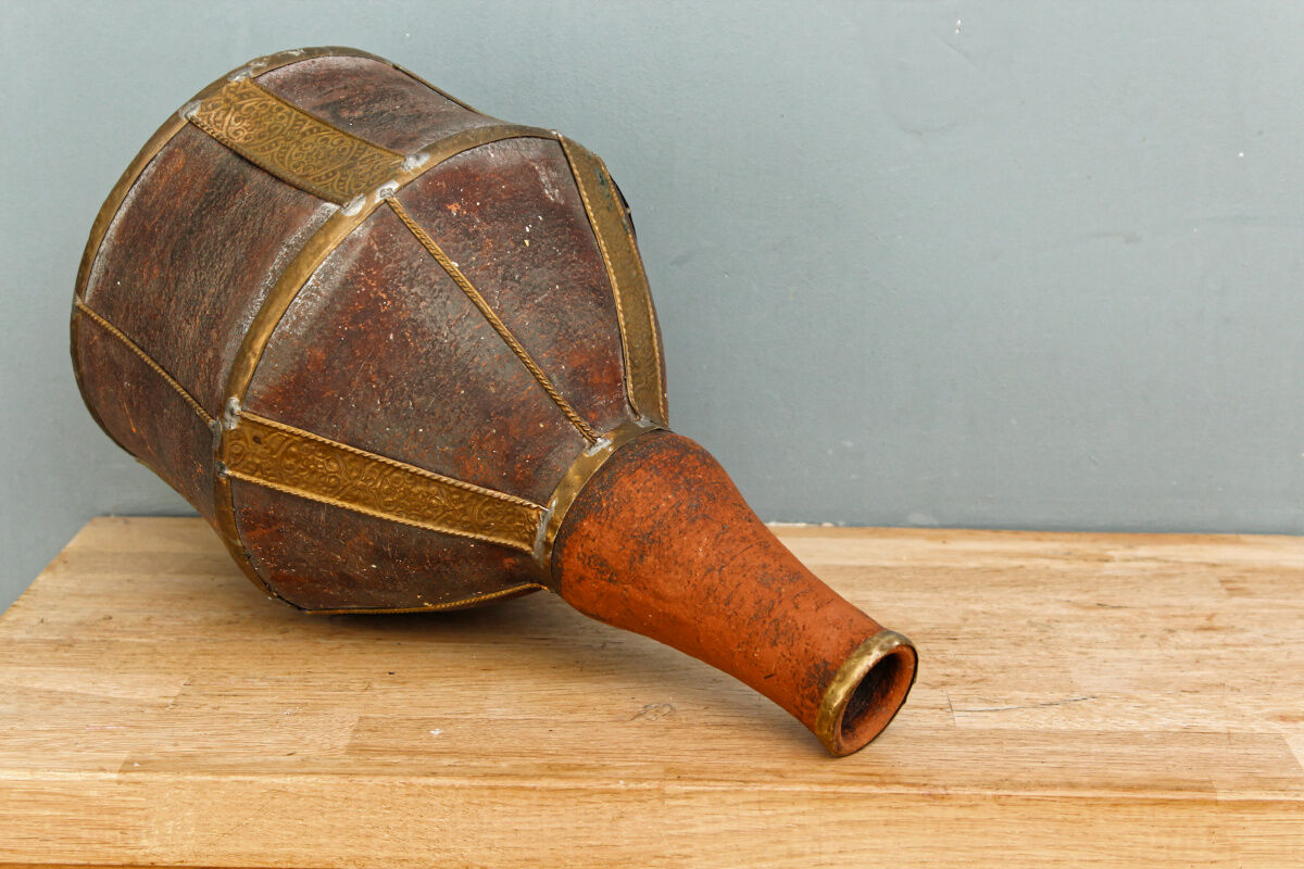 Old terracotta and brass bottle