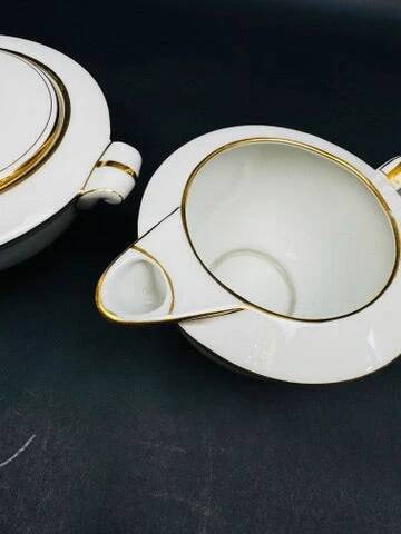 Limoges porcelain A. Vignaud sugar bowl and milk jug with gold trim