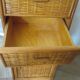Storage column, wooden bookshelf and woven rattan.