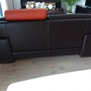 Two brown leather Crozatier two-and-a-half-seater sofas.