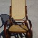 Vintage wooden rocking chair with caning