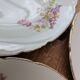 7 dessert plates in porcelain with a violet lilac design and a gold rim.