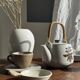 Small Asian stoneware teapot with rattan handle H11 D10