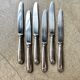 6 dessert knives by Christofle in silver-plated metal, shell decoration.