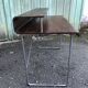 Design desk in formed glued laminated wood with chrome tubular base.
