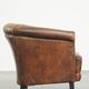 Neat, elegantly finished, cozy sheepskin club armchair with a fixed seat cushion