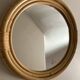 Round mirror from the 1960s with a frame made of rattan and metal.