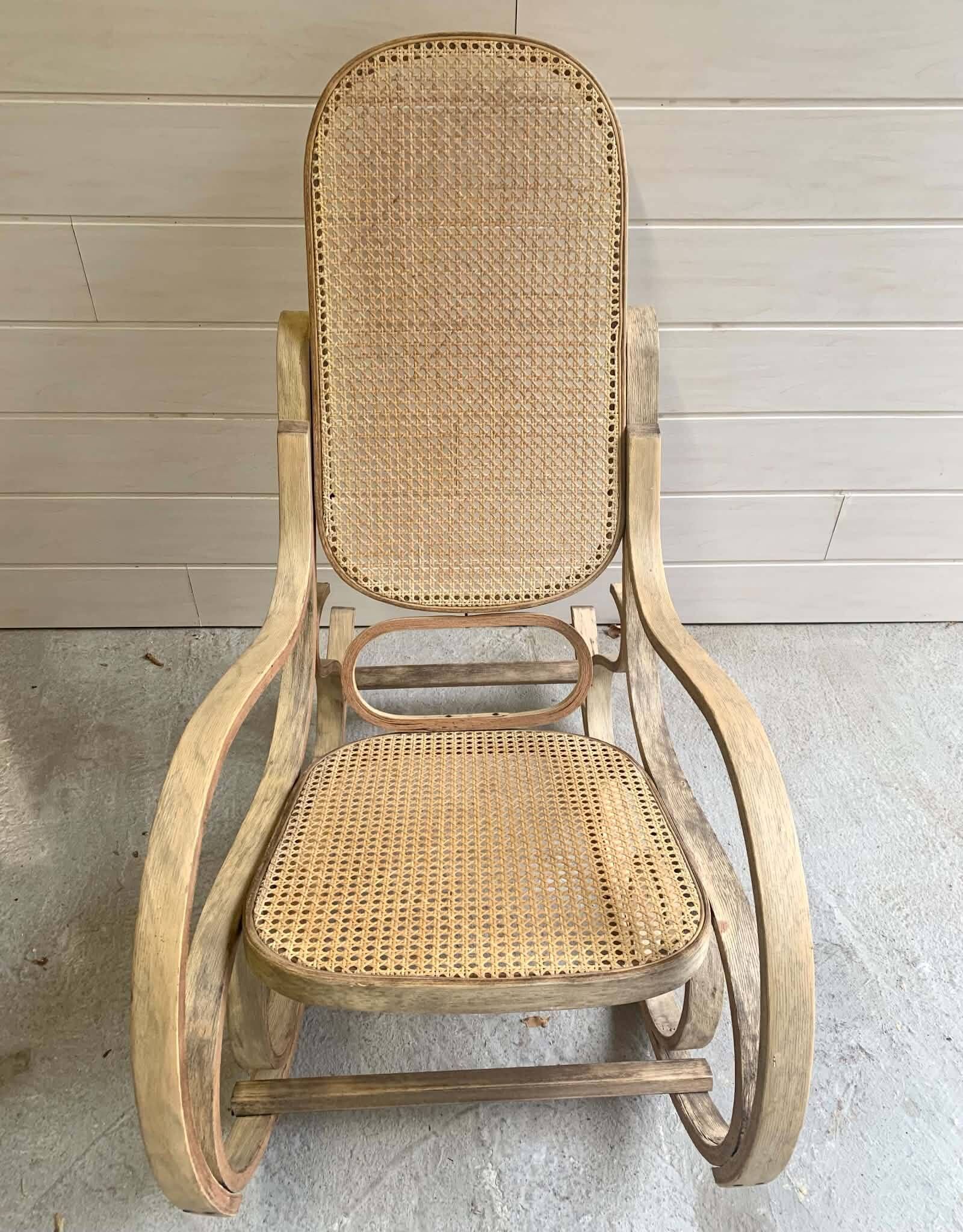 Rocking chair with a cane seat and backrest.