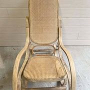Rocking chair with a cane seat and backrest.