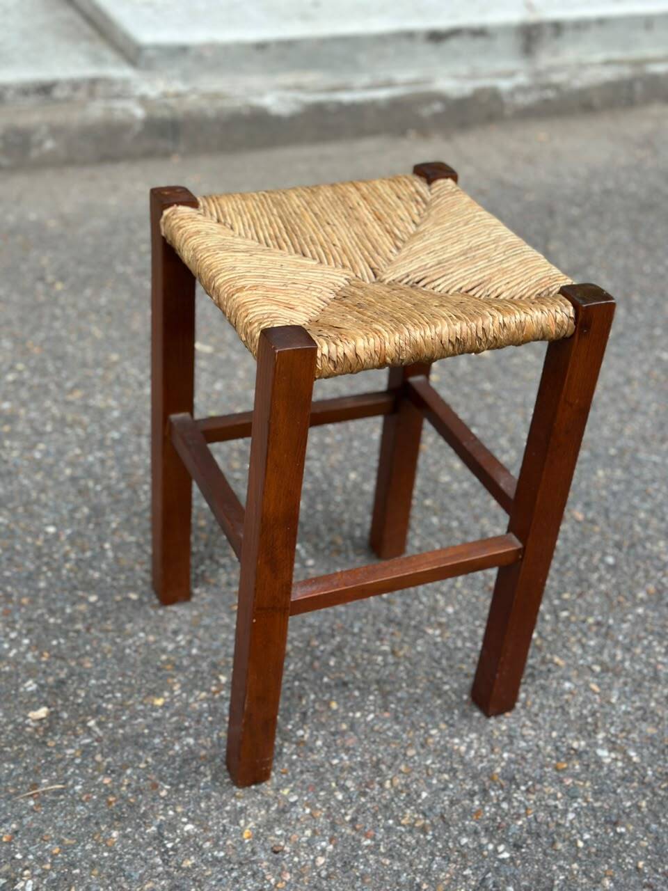 Low stool in brutalist style made of solid wood with straw, 1980.