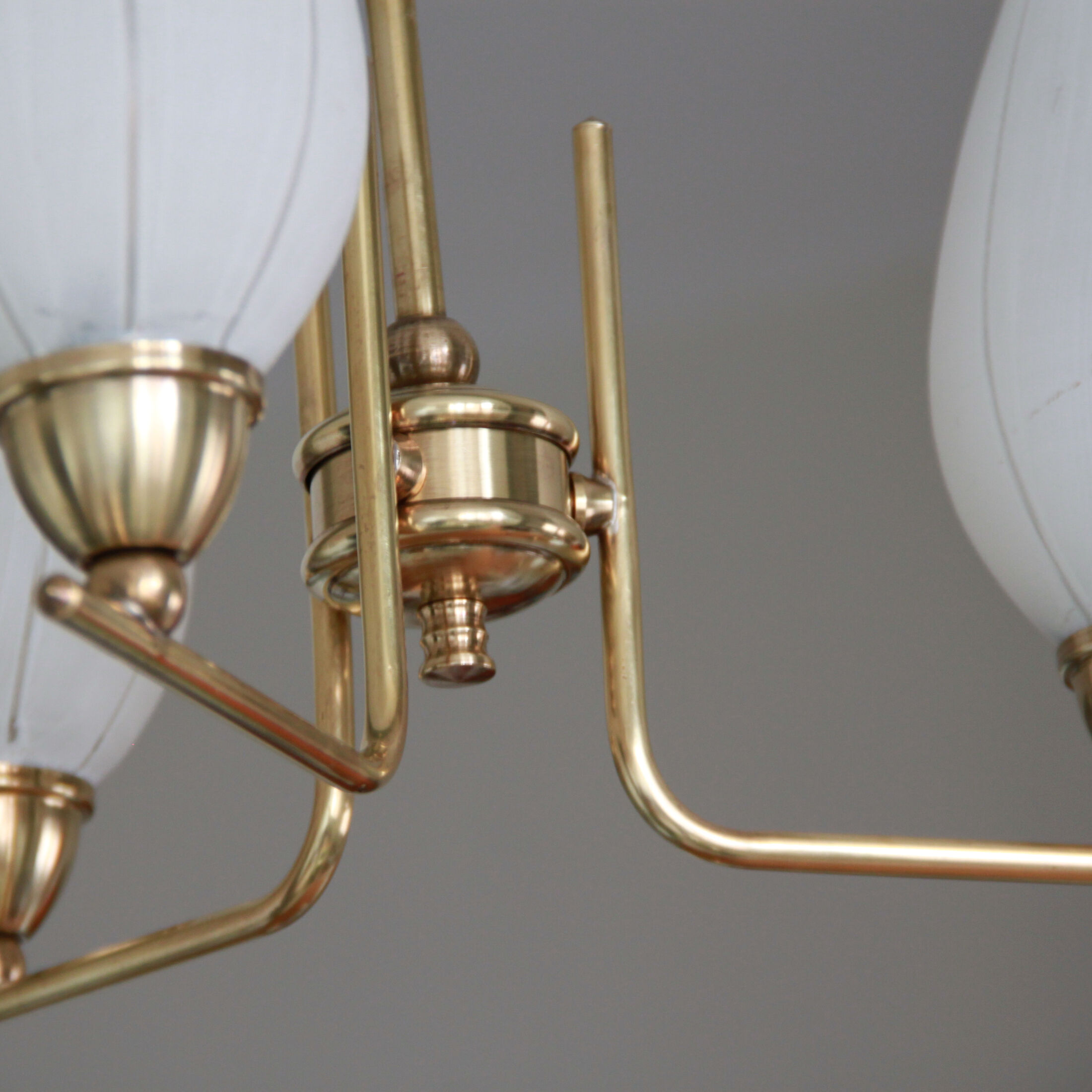 Brass chandelier and tulips in vintage white glass