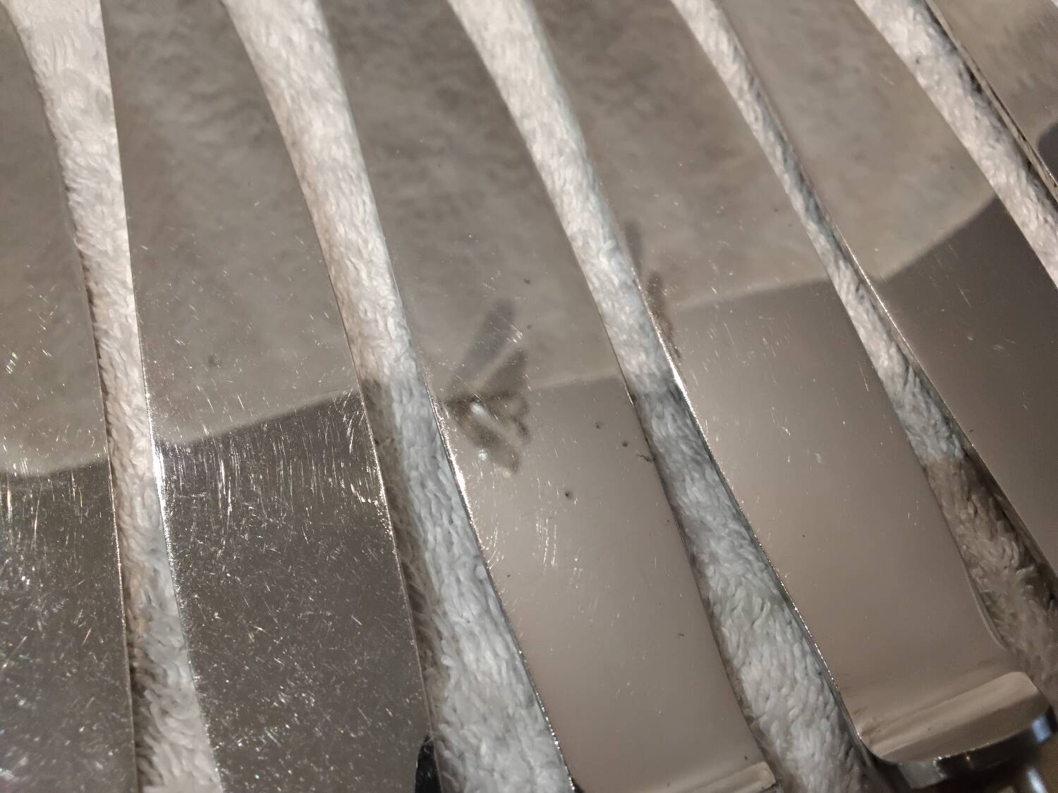 12 silver-plated table knives, Christofle goldsmith ribbons