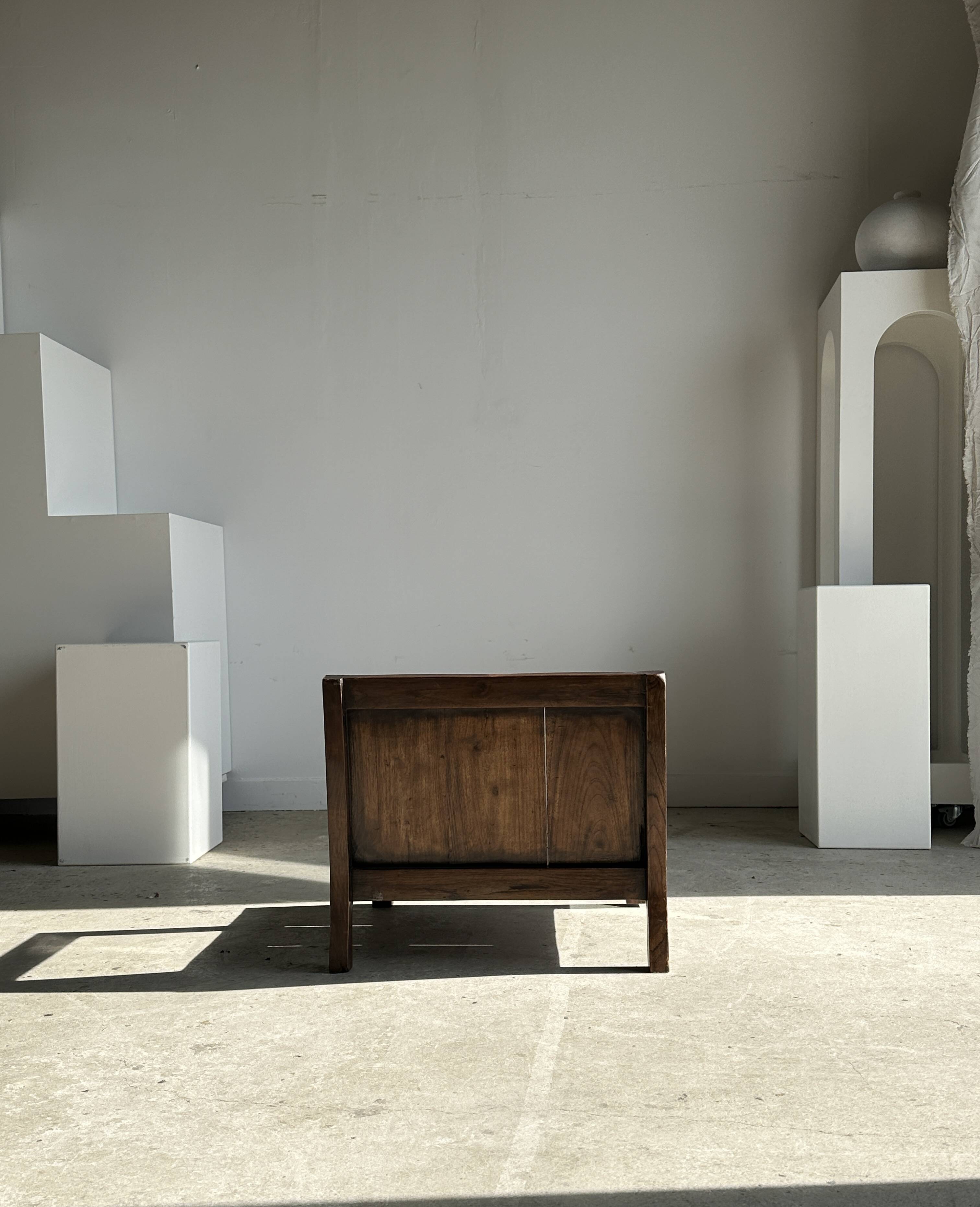 Small low armchair in varnished brown wood
