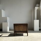 Small low armchair in varnished brown wood