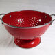 Colander on foot in red enamelled metal