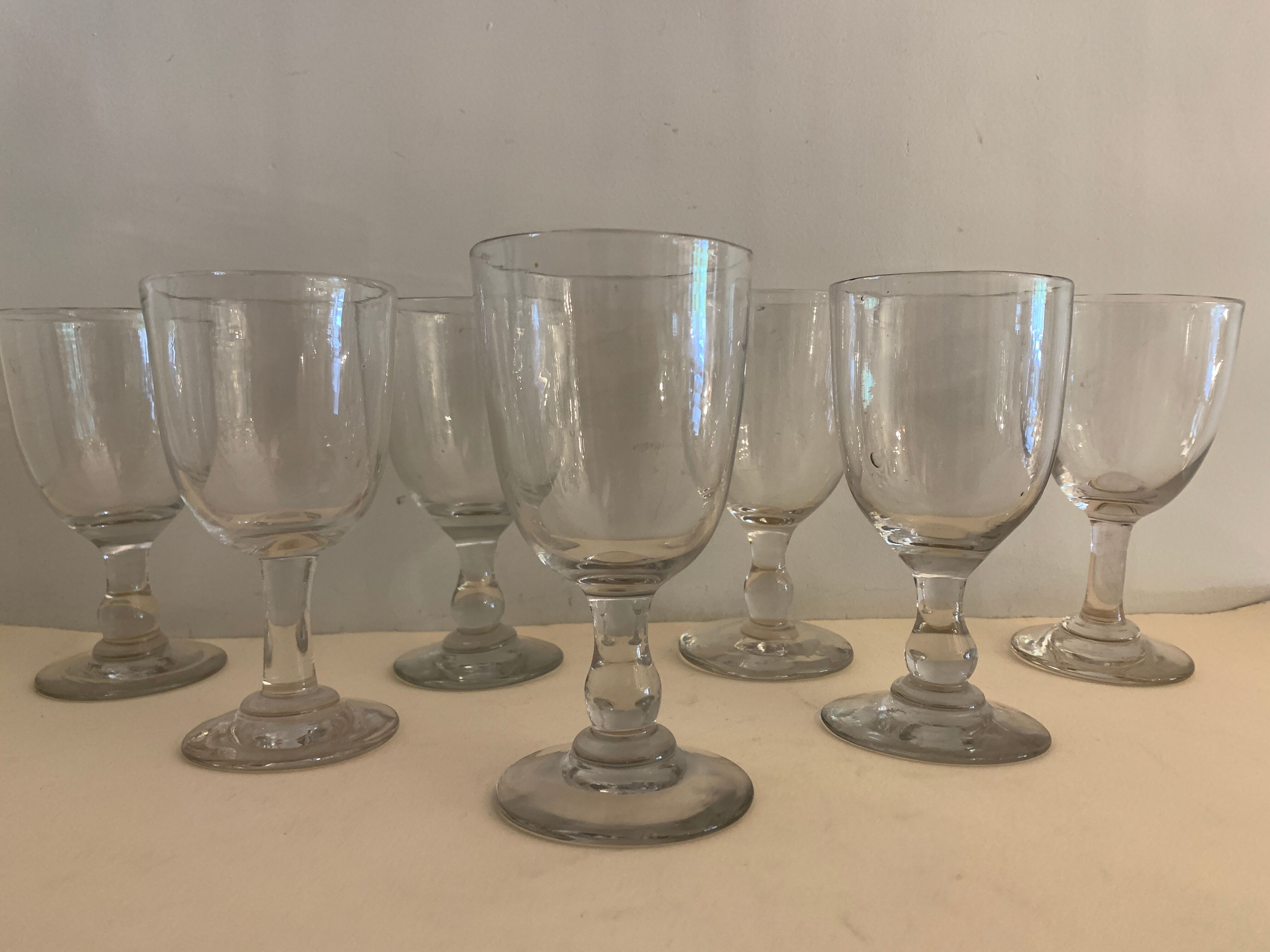 7 antique blown foot glasses
