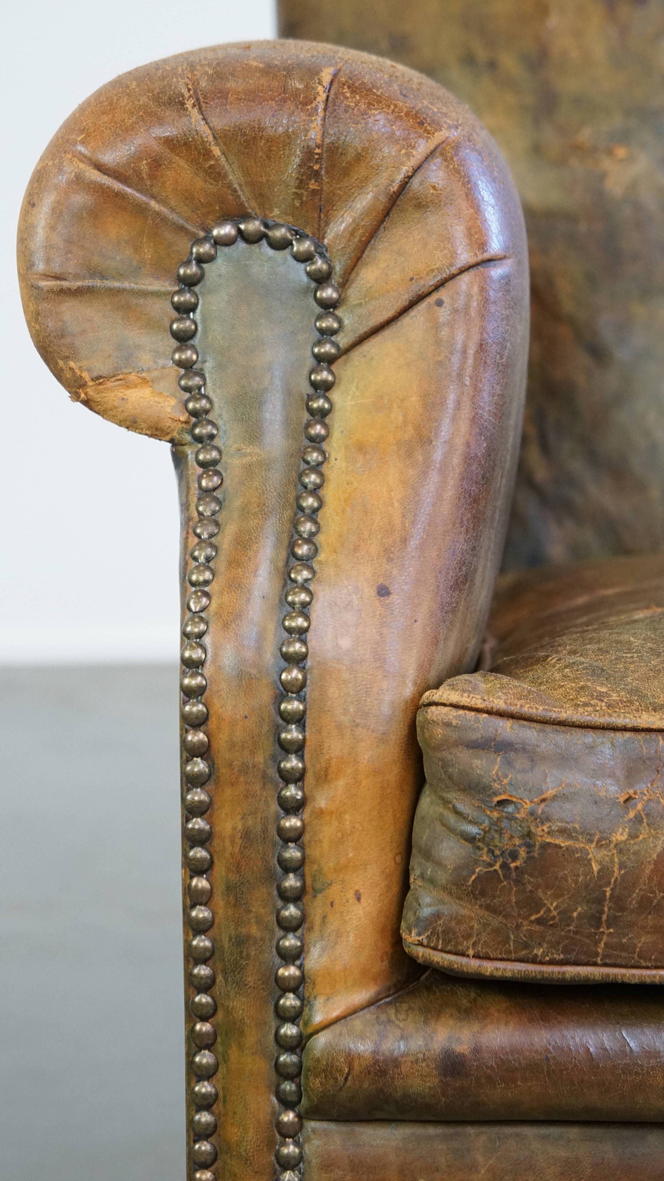 Green antique English cowhide leather armchair on wheels