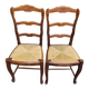 2 dining chairs with carved solid wood and rush seats in Louis XV shell style.