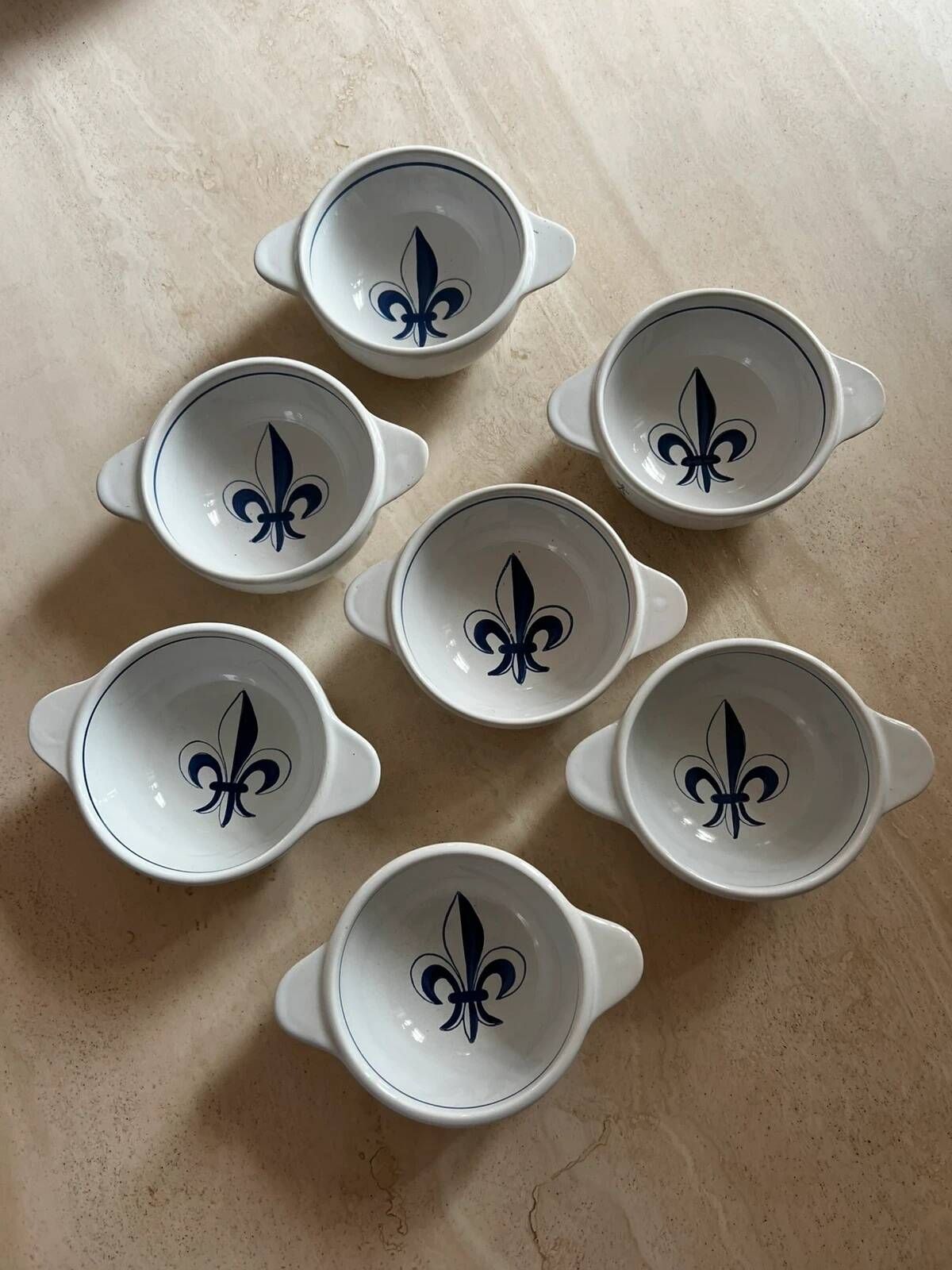 Set of seven earthenware bowls, Quimper, lily flower decoration.