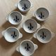 Set of seven earthenware bowls, Quimper, lily flower decoration.