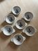Set of seven earthenware bowls, Quimper, lily flower decoration.