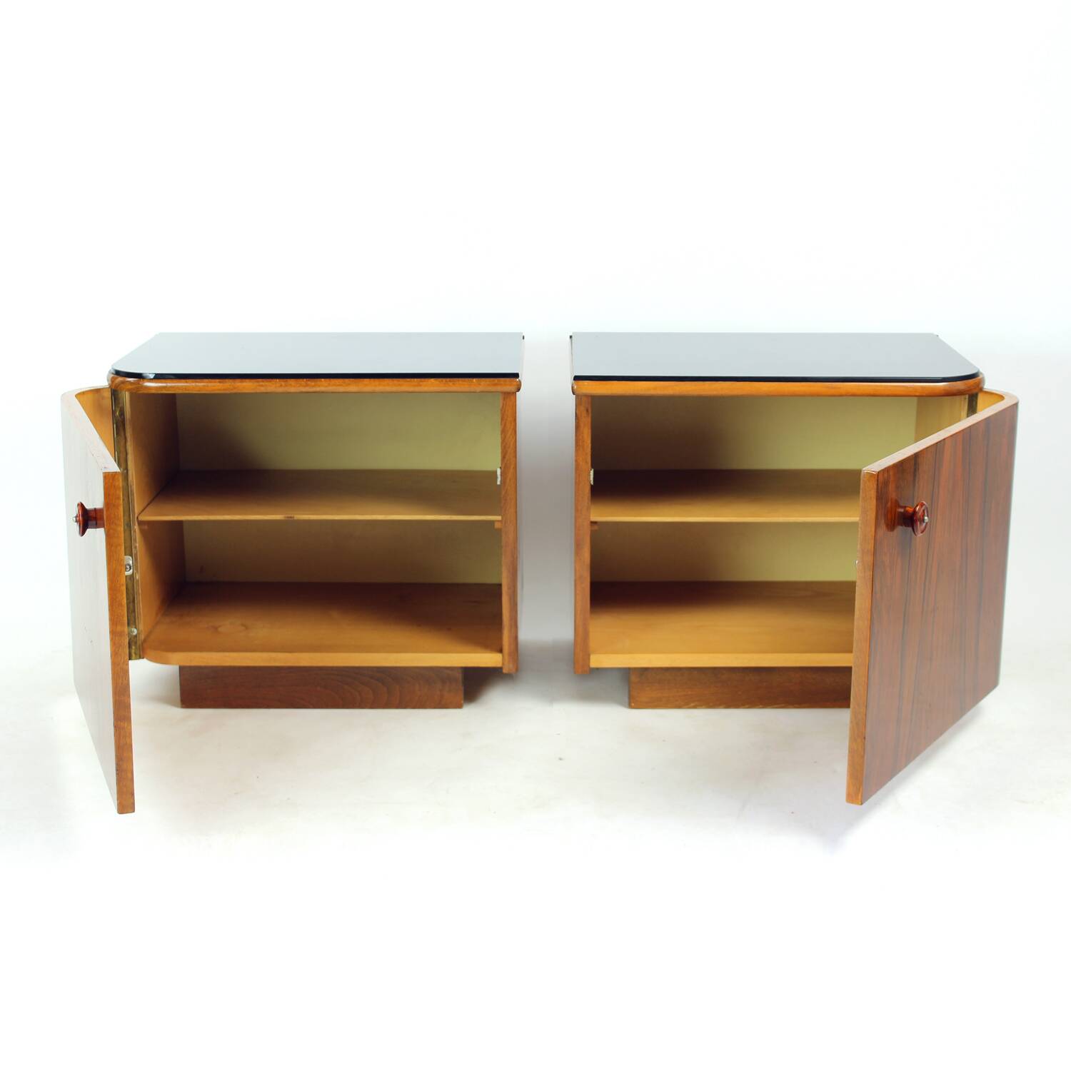 Pair of Art Deco bedside tables in walnut and black glass, Czechoslovakia.