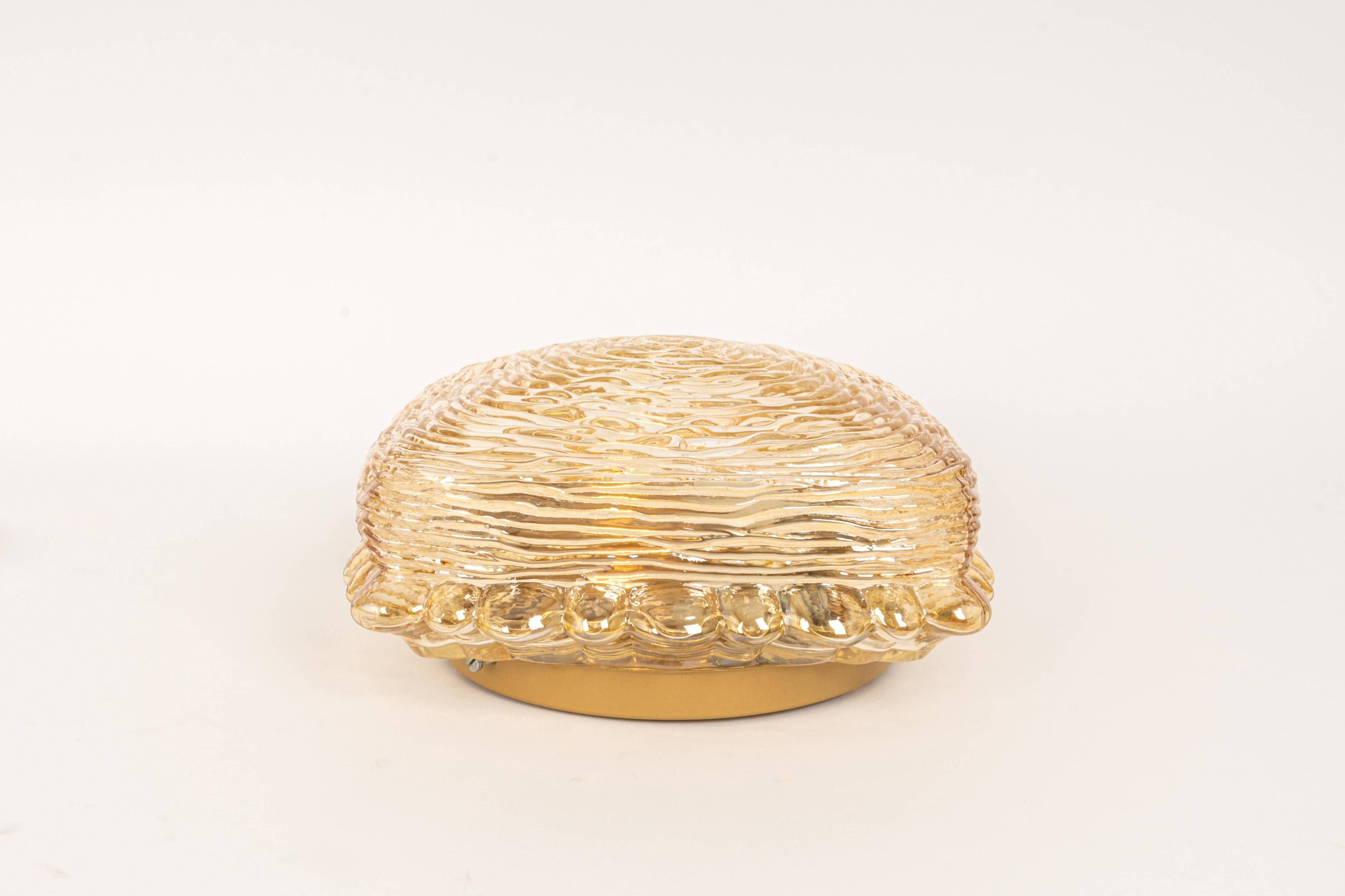 Pairs of amber glass wall lights in the shape of a fingerprint, Germany, 1970s.