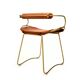 Bar stool with a vintage brass backrest and natural brown leather.