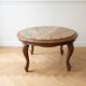 Classic round coffee table in wood with a marble top.