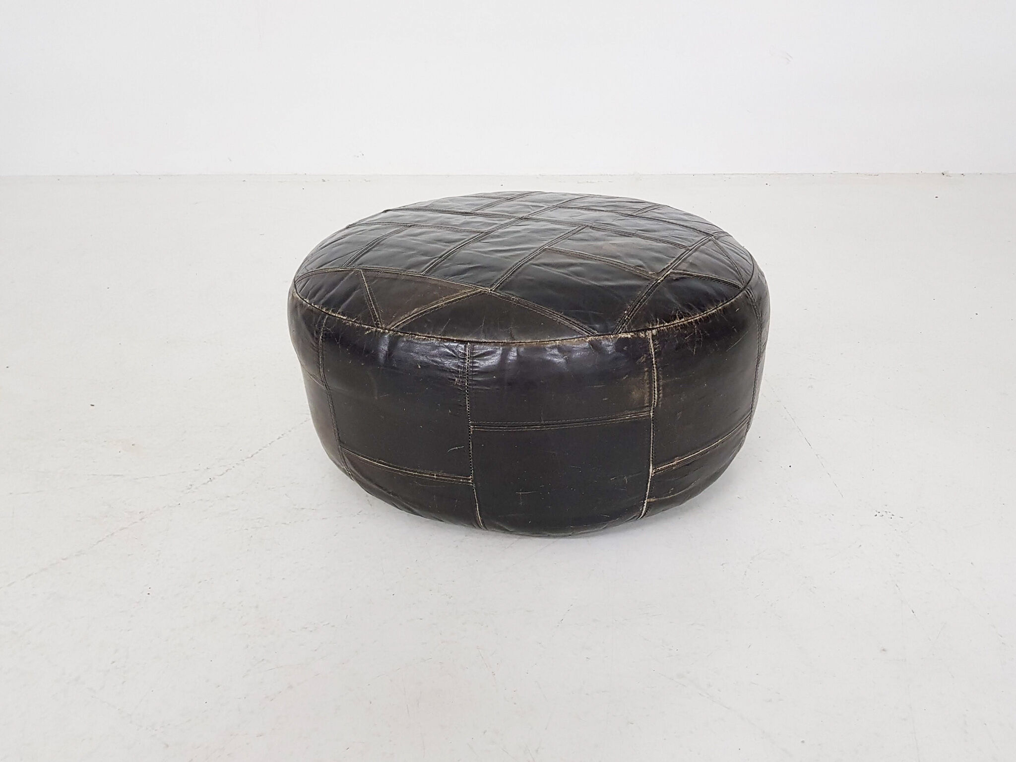 Mid-century round leather ottoman