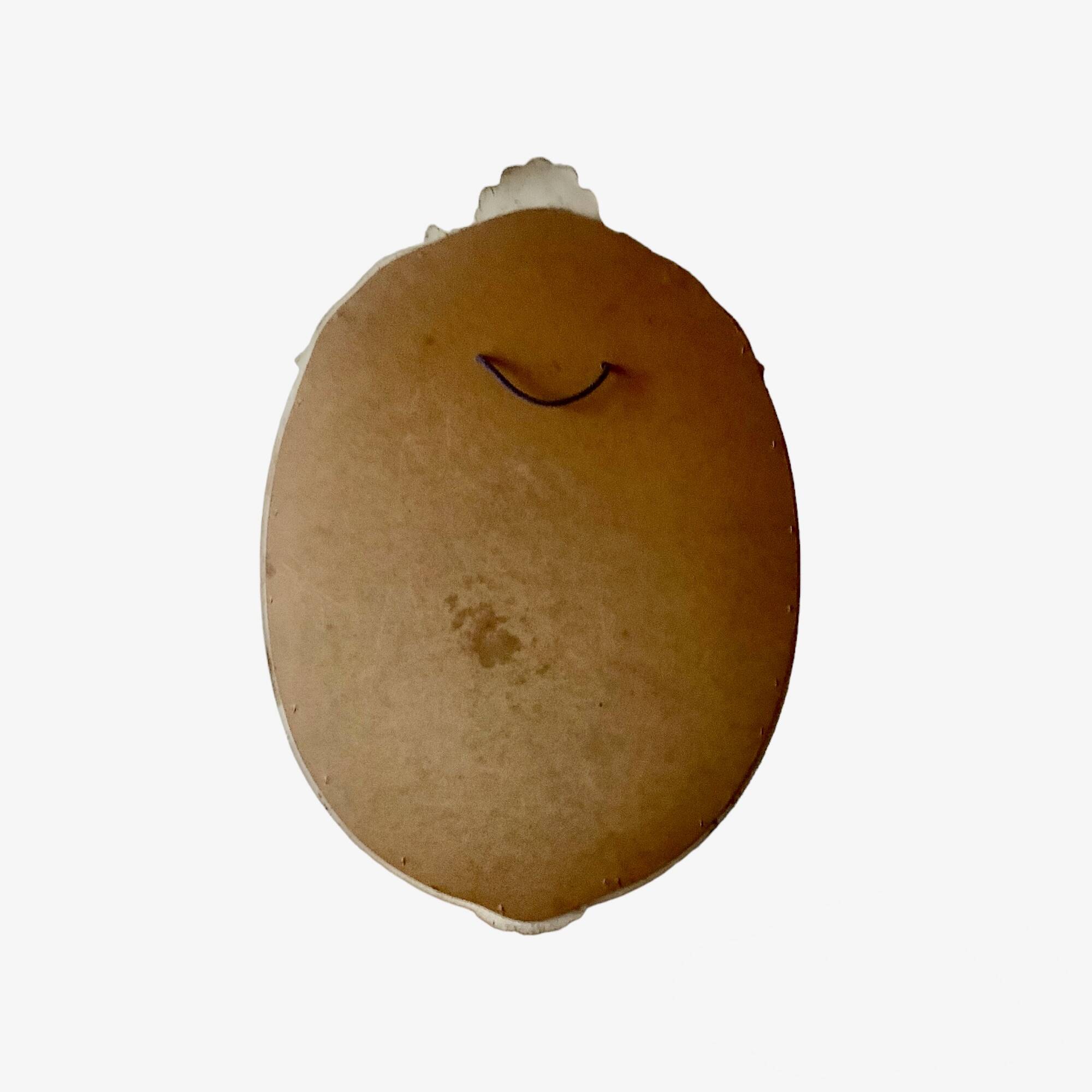 Vintage oval mirror in carved wood in pastel tones