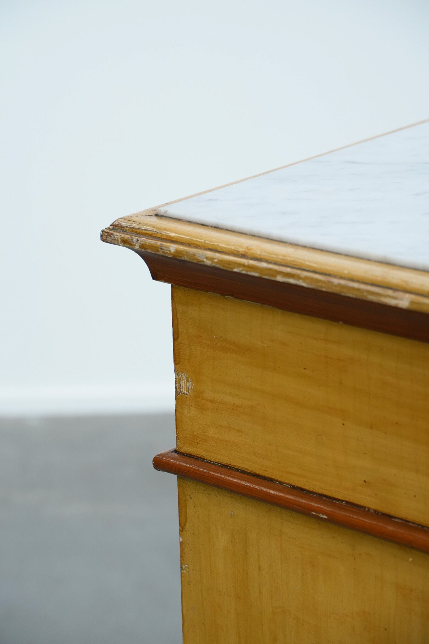 Antique wooden 1-door hallway/nightstand with a light marble top