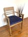 Art Deco armchair in solid wood and blue corduroy fabric.