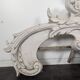 Large rococo fronton in stucco and carved wood, patinated white with an oculus.
