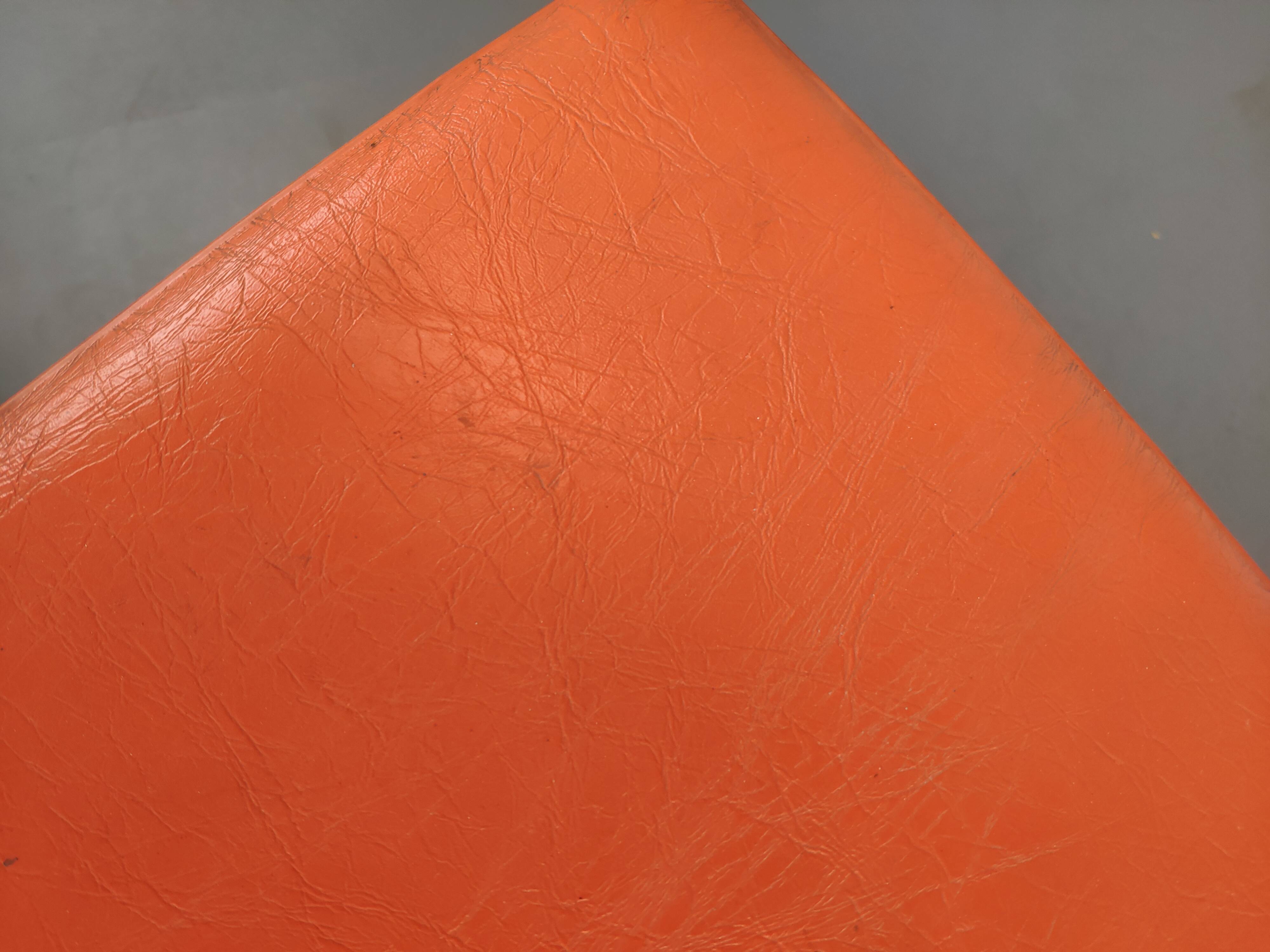 Old swivel orange sitting dentist stool